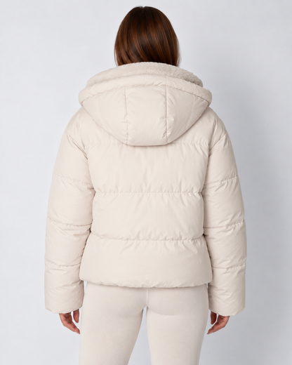 Back view of a cream puffer jacket with the hood down, showing horizontal quilted channels 4