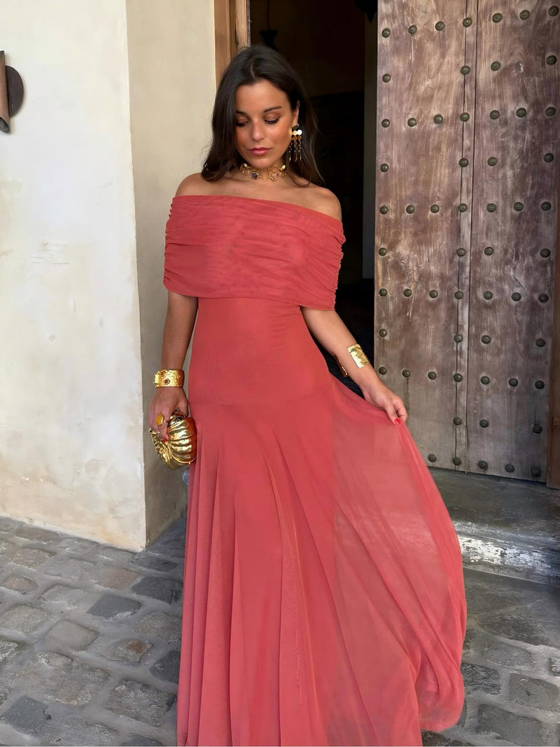 Model holding out the sheer terracotta skirt, showing the off-the-shoulder bodice and its floaty drape 8