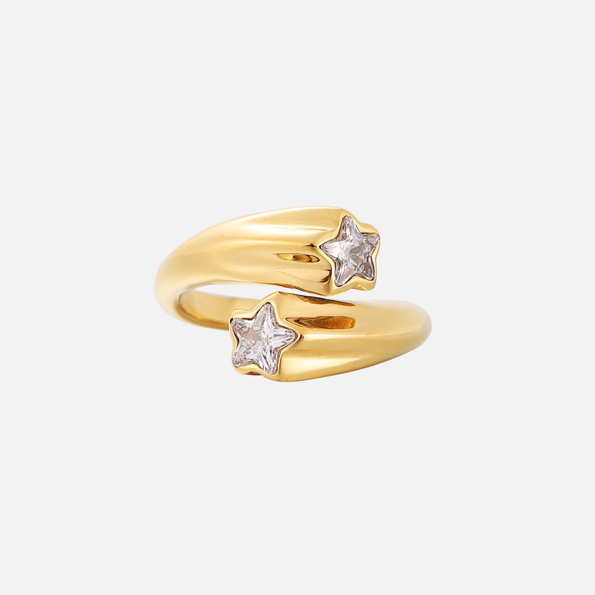 Gold open wraparound ring with a clear star-shaped crystal set in each end, shown from the front on a plain pale background. 1