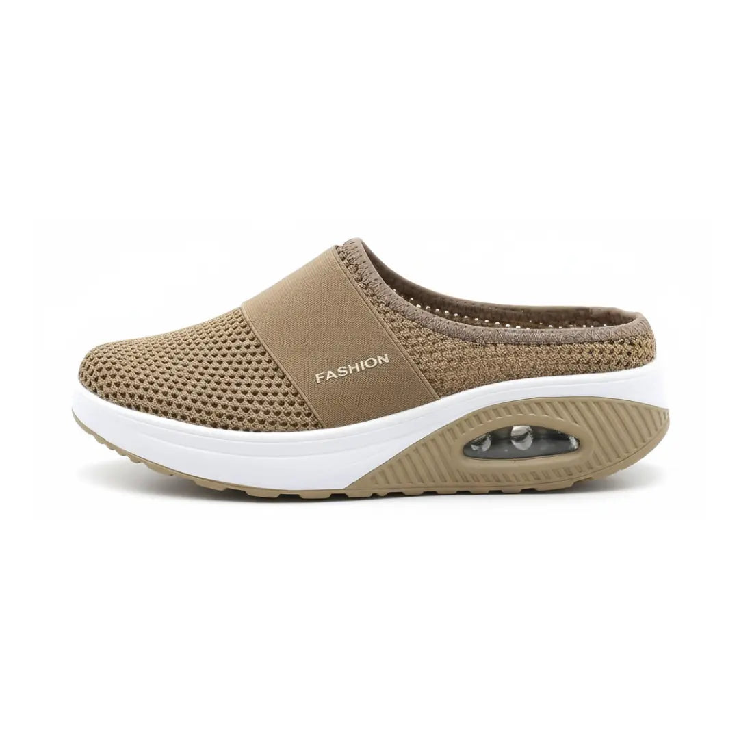 Side view of a single tan mesh mule with elastic strap, white midsole and visible air cushion. 17