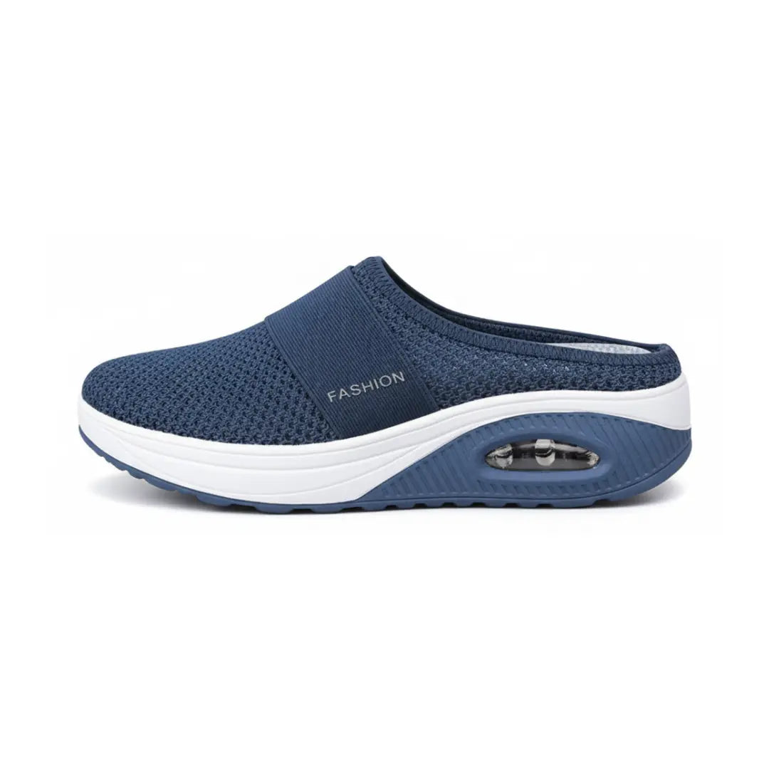 Side view of a single navy mesh mule showing the elastic strap, white midsole and air cushion window. 14
