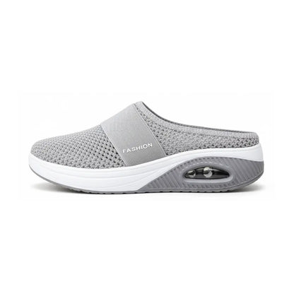 Side view of a single light grey mesh mule with elastic strap and visible air cushion in the sole. 5