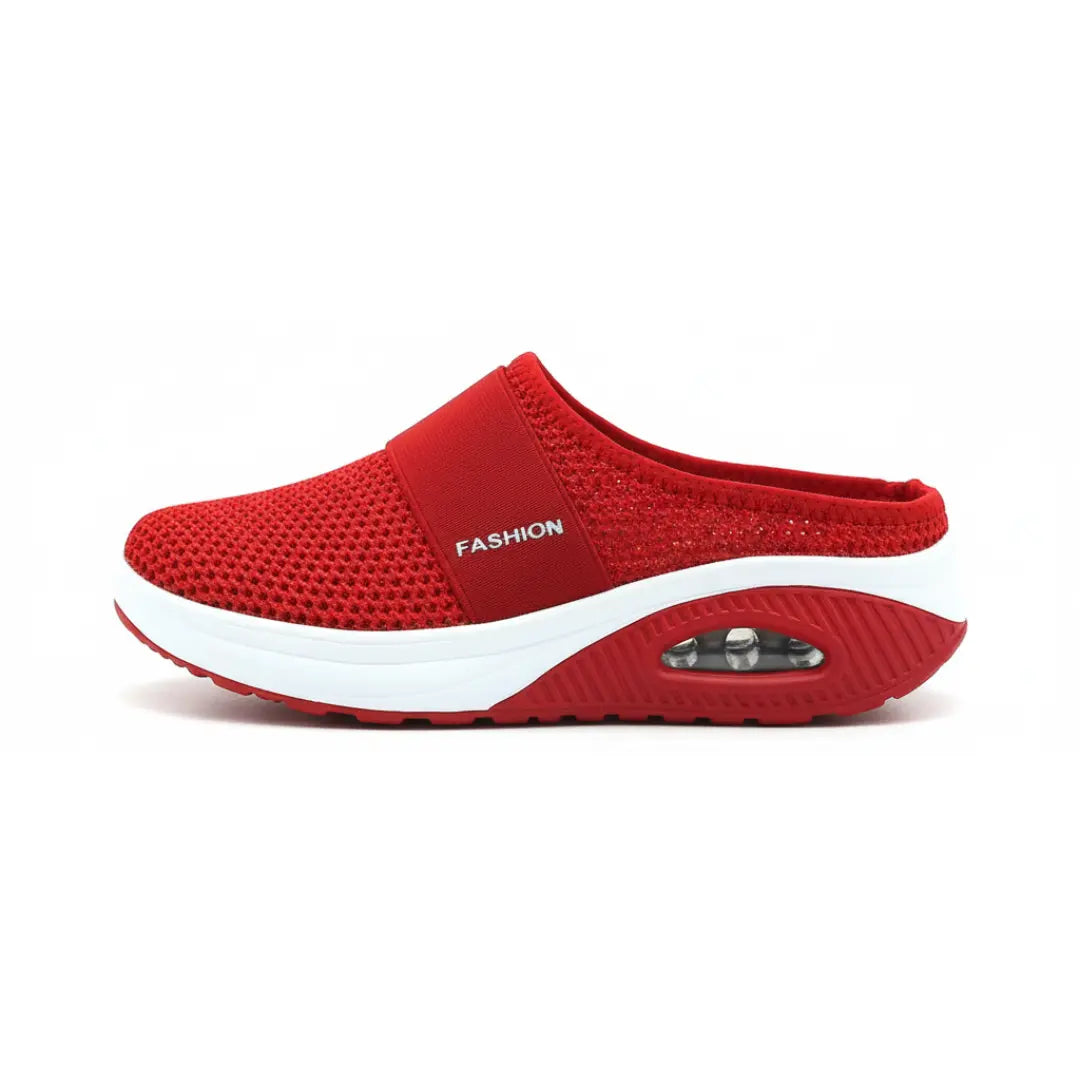 Side view of a single red mesh mule showing the elastic strap, white midsole and transparent air cushion. 20