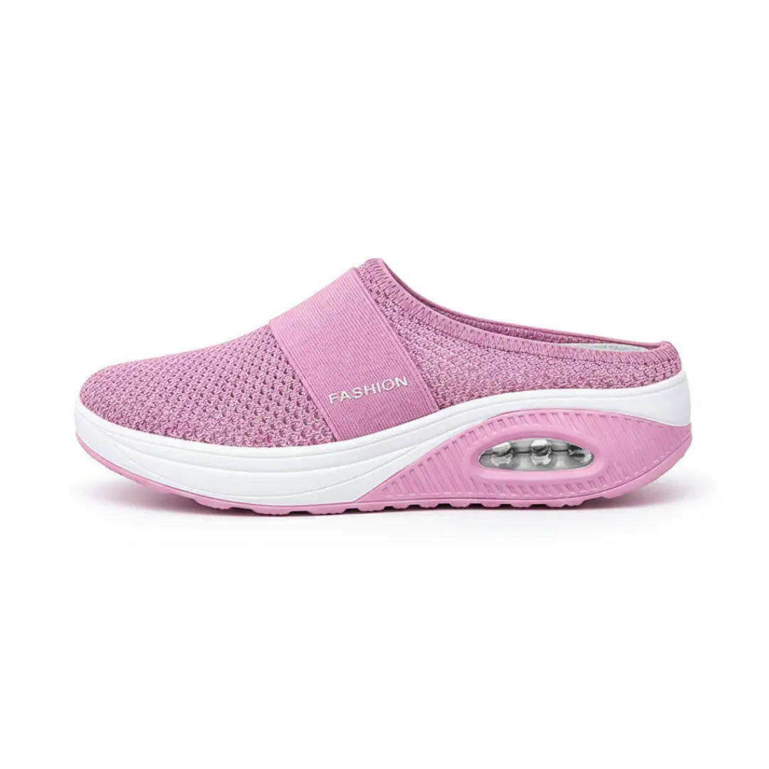 Side view of a single pink mesh mule showing the elastic strap, white midsole and transparent air cushion window. 2
