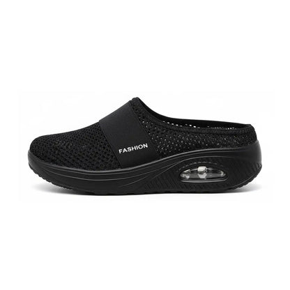 Side view of a single black mesh slip-on sandal showing the elastic strap and the transparent air-cushion window in the thick sole. 23