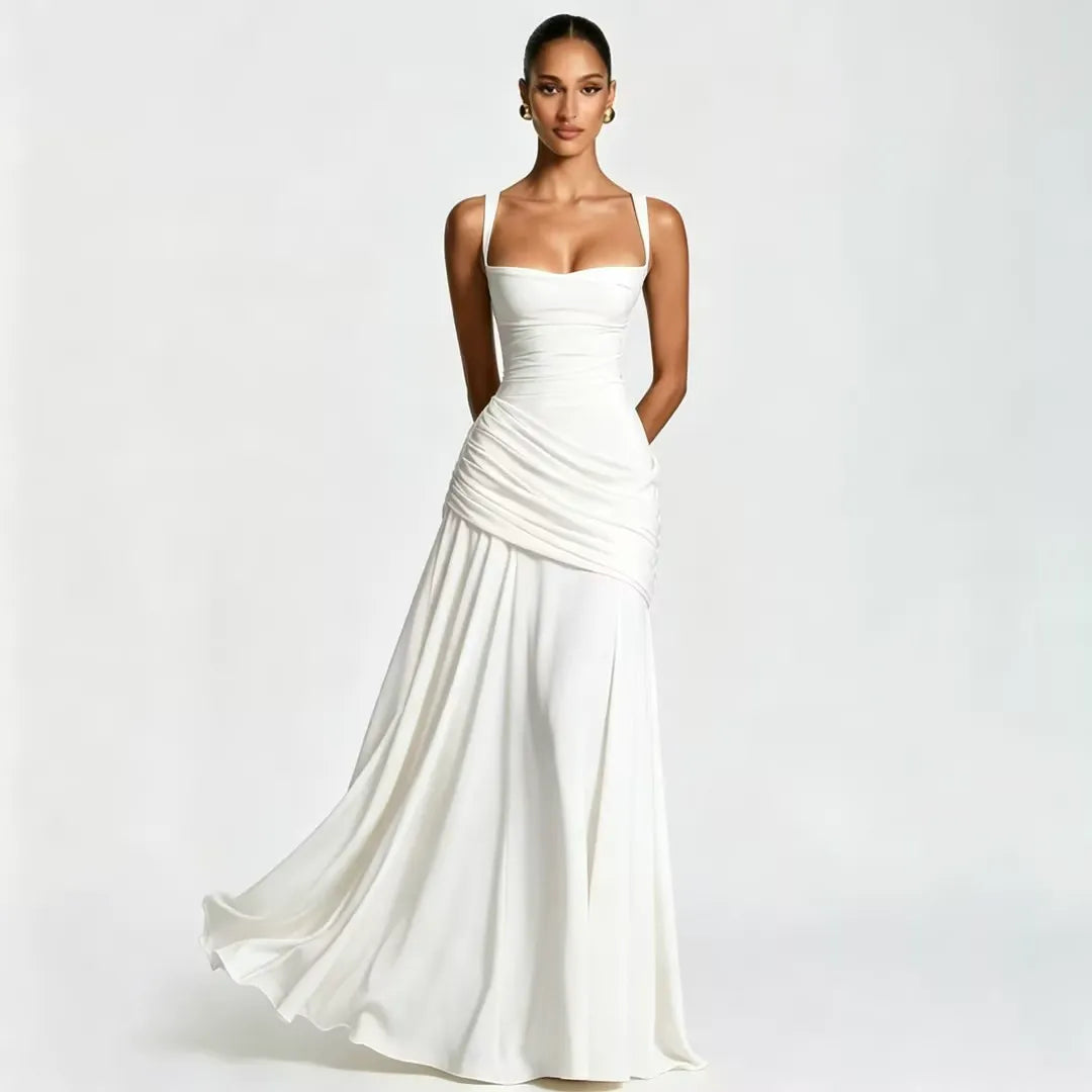 White version of the maxi dress on a model, with flowing skirt in motion and draped, gathered waist. 19