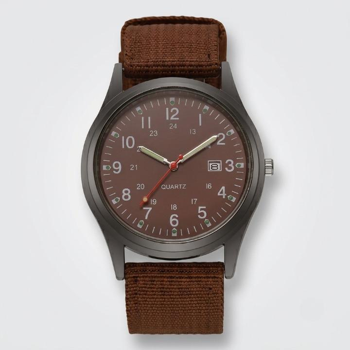 Front view of the watch with a brown dial, luminous hands, date window and brown woven nylon strap on a plain background. 6