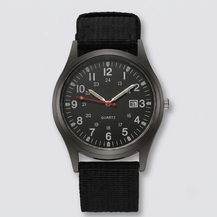 Front view of the watch with a black dial, luminous hands, date window and black woven nylon strap on a plain background. 1