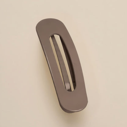 Matte taupe-brown flat clip with a slim oval opening, slightly curved, shown from above 8