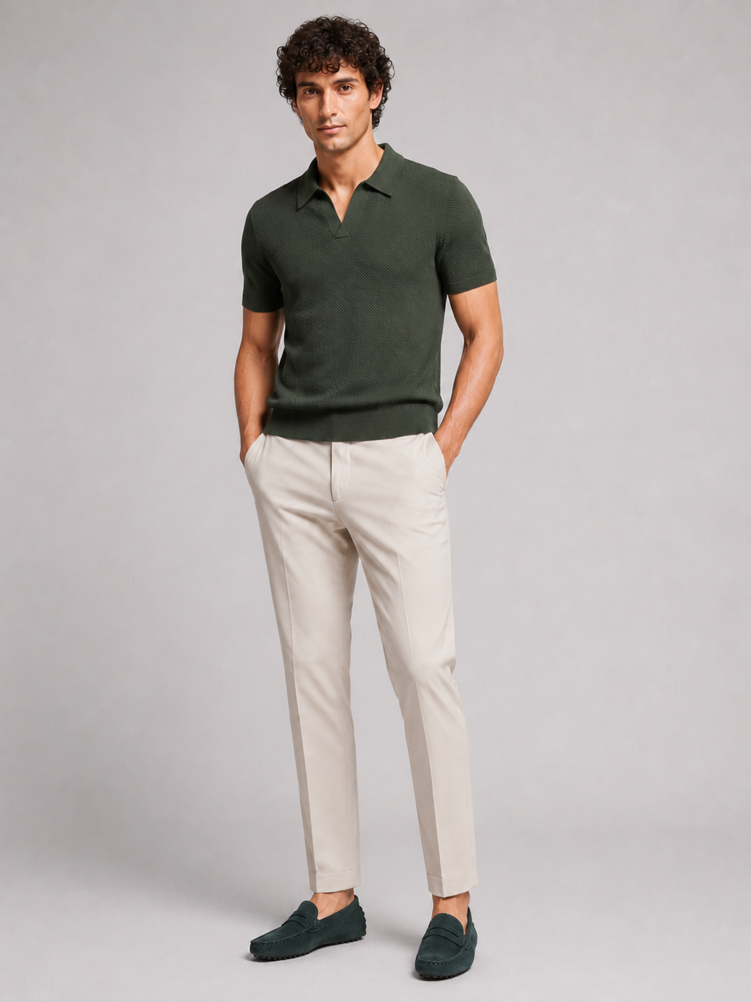 Full-length front view of model in dark green knit polo, beige trousers and green suede loafers 13
