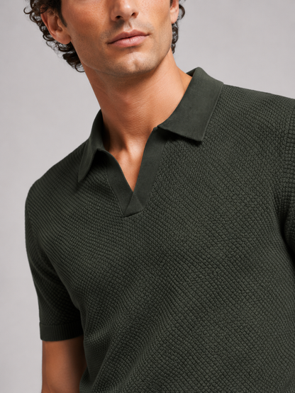 Close-up of dark green knit polo showing the open V collar and woven-look texture 12