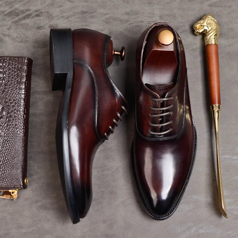 Flat lay of a burgundy Oxford seen from above and a second on its side, showing the heel 6
