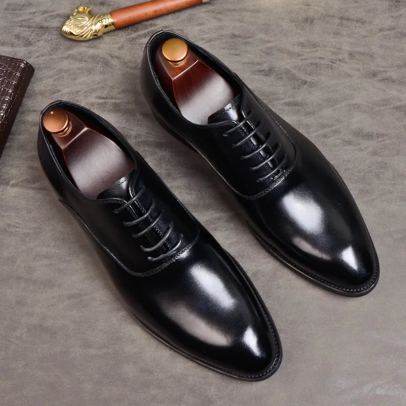 Flat lay of black polished leather Oxfords with wooden shoe trees on a grey textured surface 8