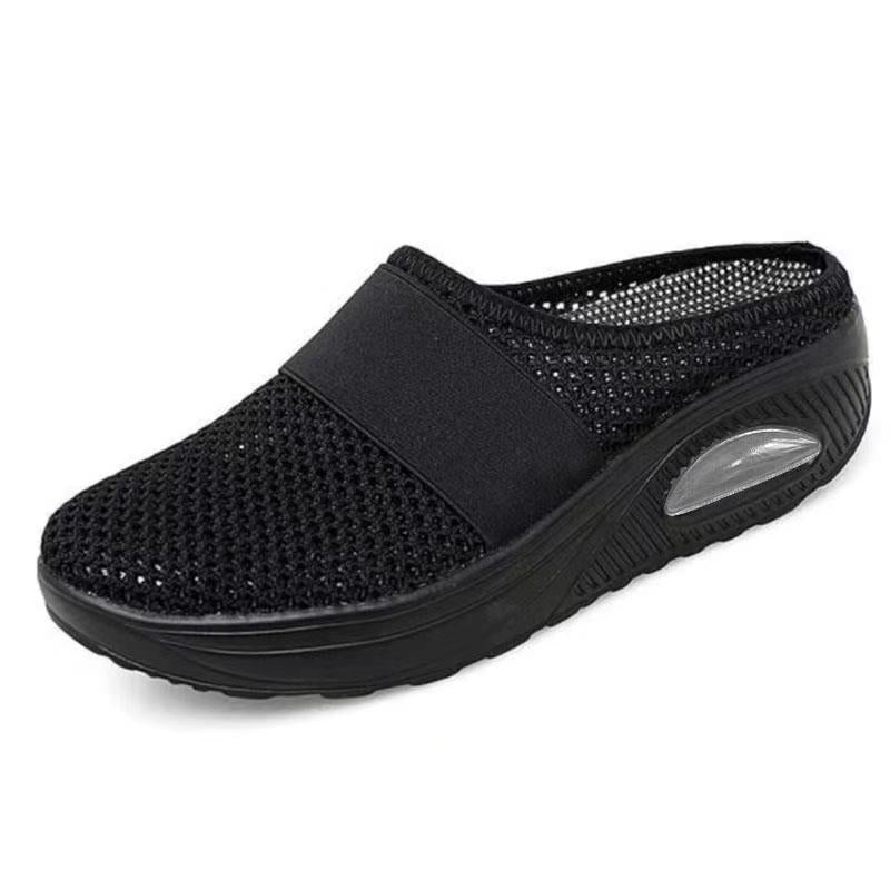 All-black mesh backless slip-on with elastic strap and clear air cushion window in the heel 10