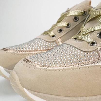 Close-up of the toe of beige trainers, showing the sparkly studded panel, gold laces, metal eyelets and rose-gold edging. 10