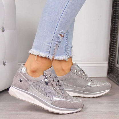 Grey version of the zip-sided trainers with silver metallic panels, worn by a model with frayed ripped jeans. 2