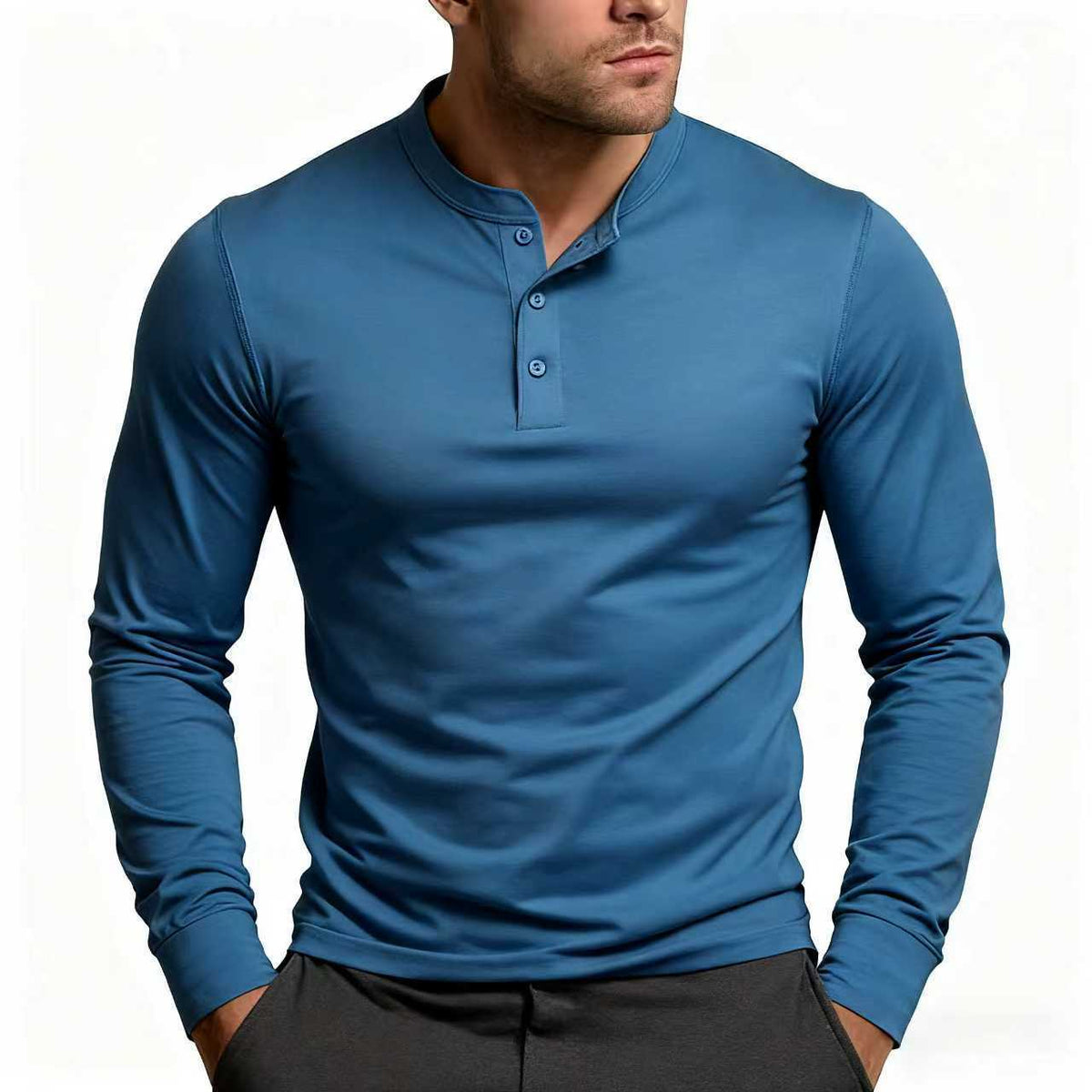 Model wearing the long-sleeve Henley in mid blue, with the placket partly unbuttoned and a stand-up collar, over dark trousers. 7