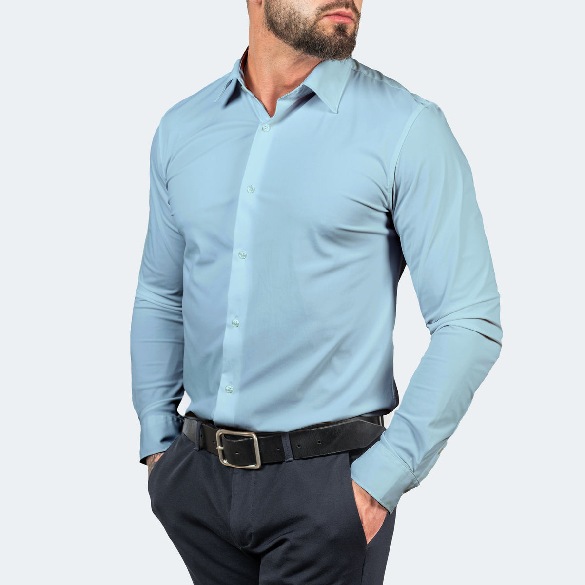 Light blue shirt worn with navy trousers and belt, model with hands in pockets 12