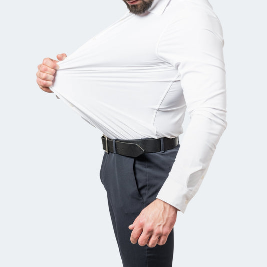 White shirt on a bearded model, side view, stretching the fabric away from the chest 1