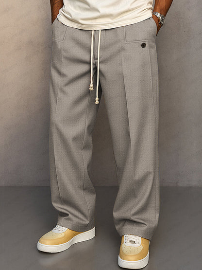 Front view of the wide-leg drawstring trousers in light grey, worn by a model with a cream t-shirt. 5