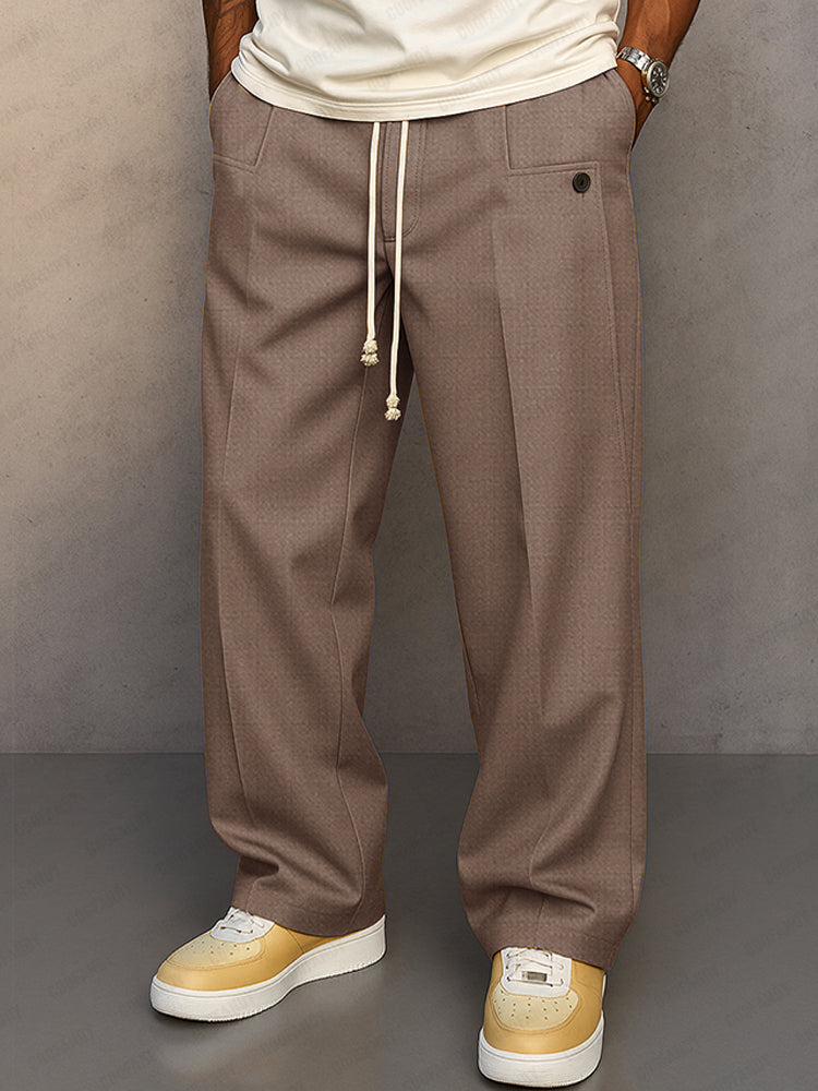 Front view of the wide-leg drawstring trousers in taupe brown, with cream drawcord and pleated front. 6