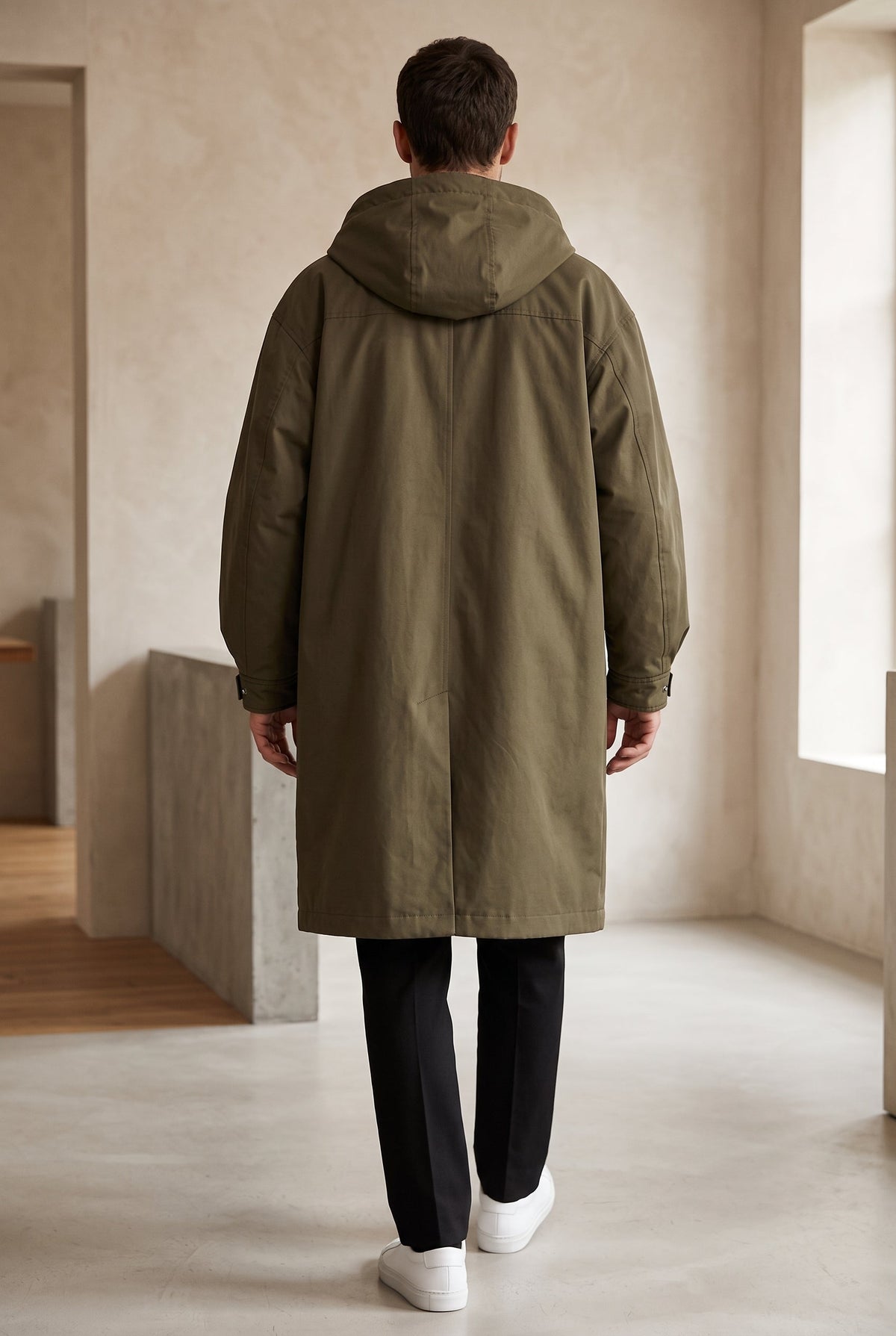 Back view of the olive-green hooded coat on a model, showing the hood and centre back seam 3