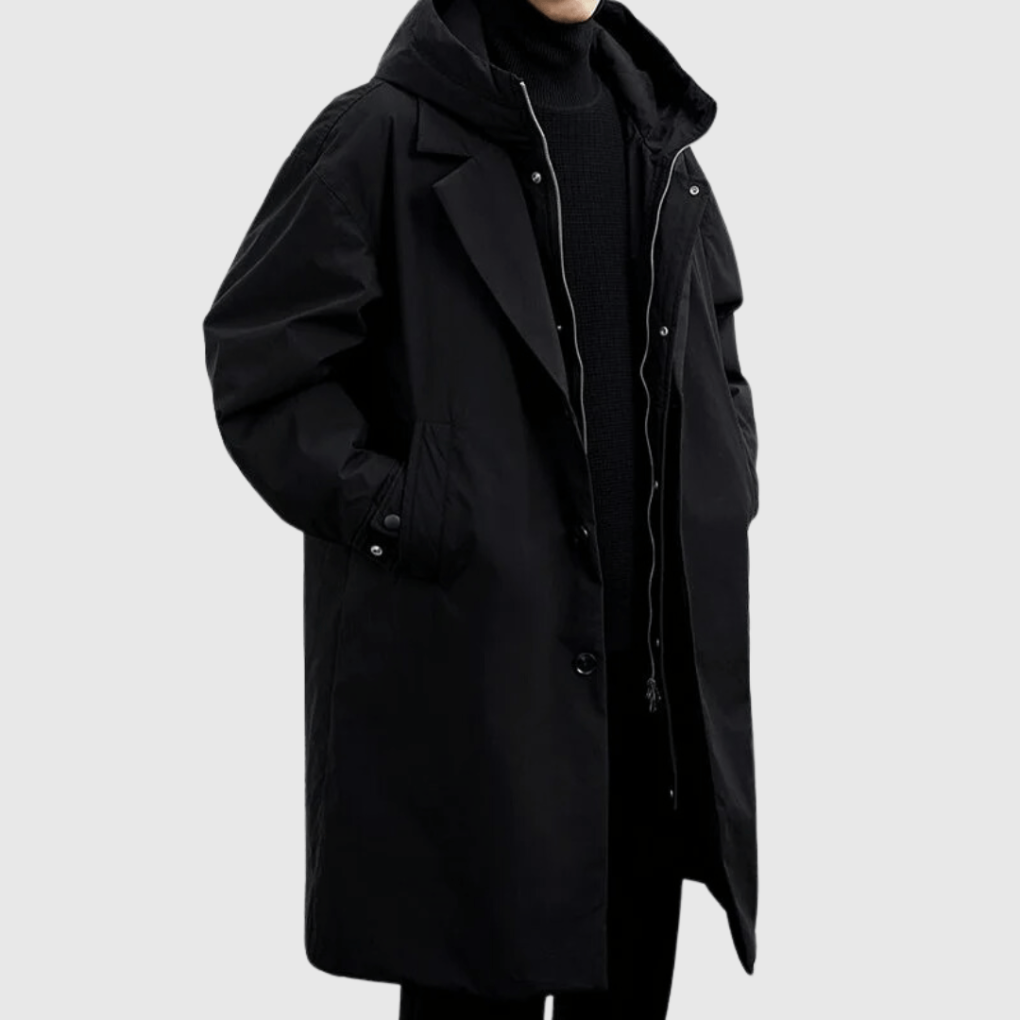 Black long hooded coat worn by a model, three-quarter view, with zip and buttons partly open 4
