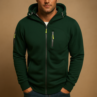 Close front view of the dark green hoodie with lime zip pulls, chest zip pocket and sleeve pocket on a model. 5
