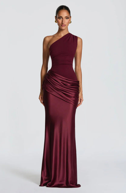 Front view of the dress in deep burgundy, with a one-shoulder bodice and glossy ruched satin skirt. 5