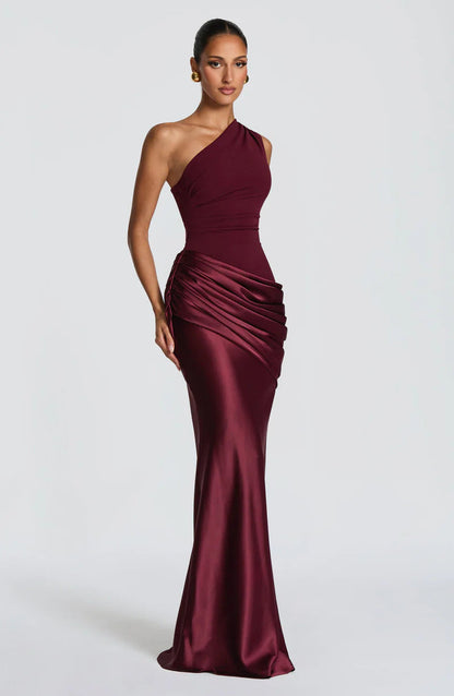 Three-quarter view of the burgundy dress, showing the gathered detail along the side of the draped hip. 6