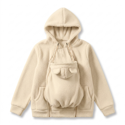 Flat lay of the hoodie in cream with the baby carrier panel zipped on, showing bear ears, double zips and side pockets. 11
