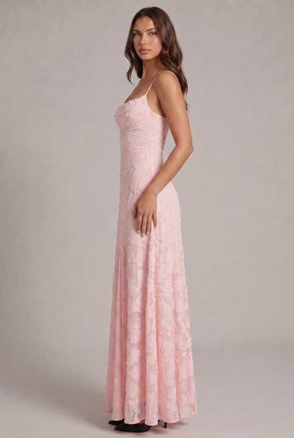 Side view of the pale pink maxi dress on a model, showing the fitted bodice and long flowing skirt. 8