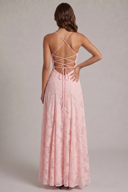 Back view of the pale pink maxi dress, showing the criss-cross lace-up open back with a bow tie and zip. 7