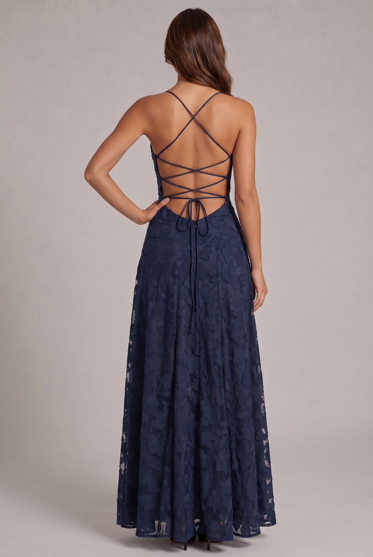 Back view of the navy blue maxi dress, showing the criss-cross lace-up open back, tie closure and zip. 19