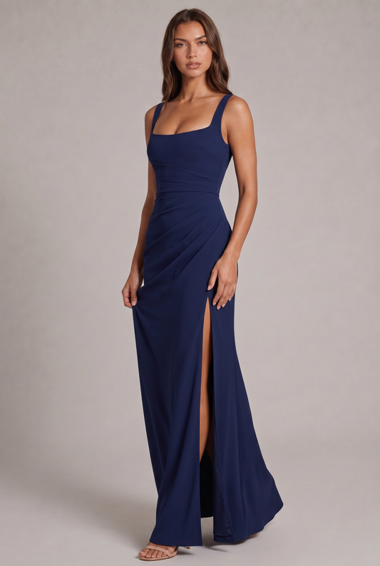 Model in a navy square-neck maxi dress with ruched waist and high side split, full-length three-quarter view, nude heels. 1