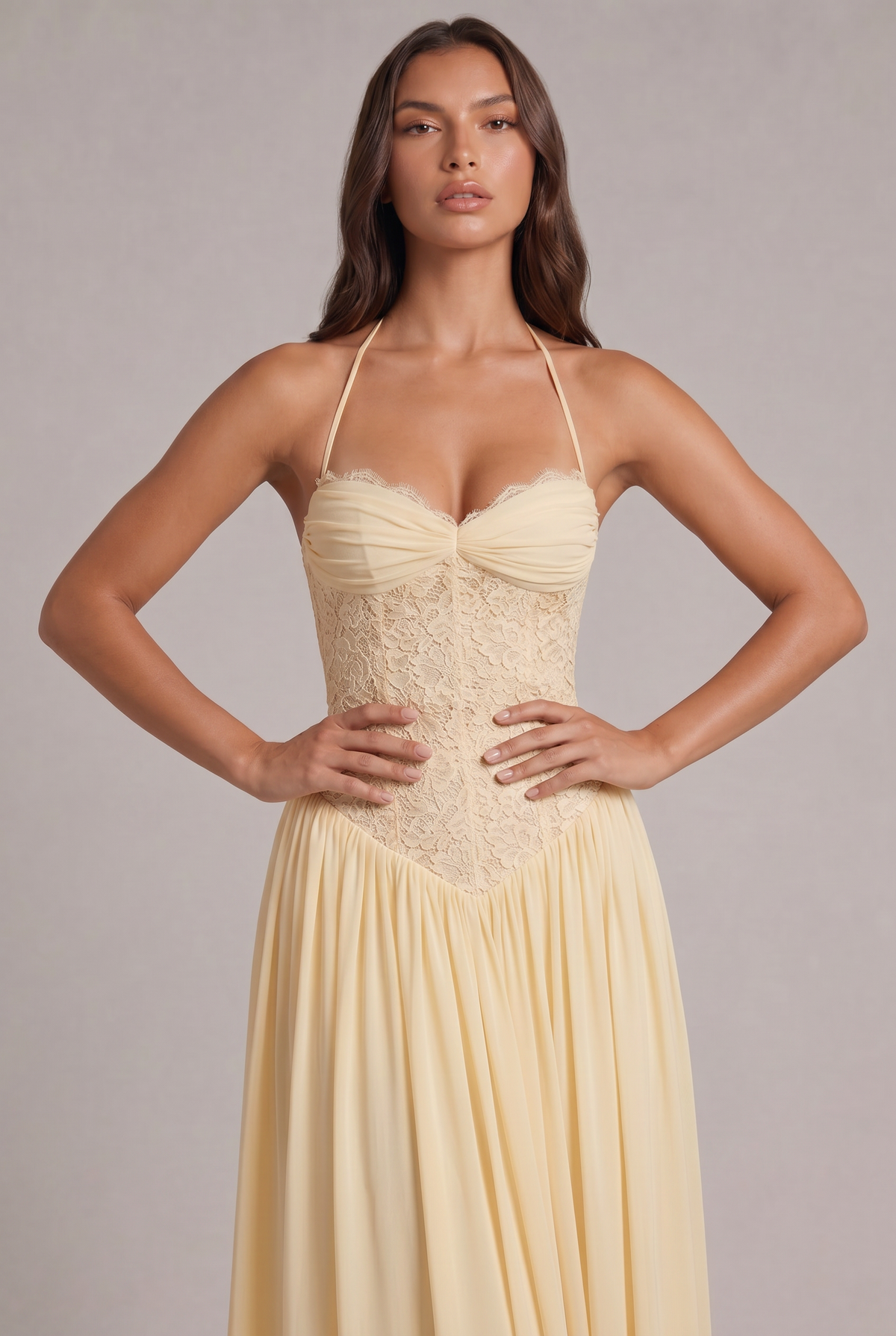 Close-up of the pale yellow dress with the model's hands on her waist, showing the ruched bust and lace corset bodice. 6