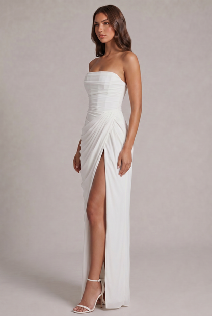Angled side view of the white gown showing pleated wrap detail and high slit 19