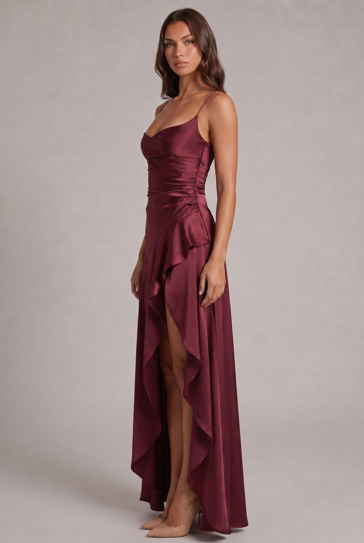 Burgundy satin maxi dress seen from the side, showing ruched waist and cascading ruffle at the slit 3