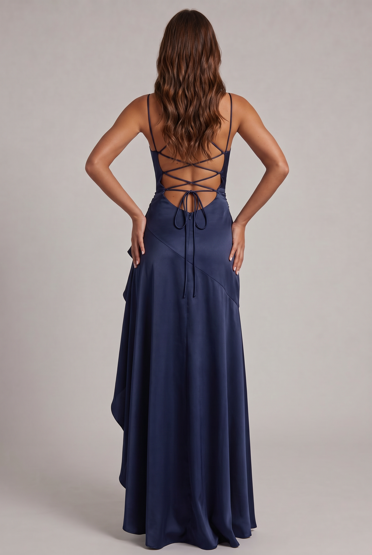 Back of the navy satin dress with criss-cross lace-up straps and tied bow above the zip 8