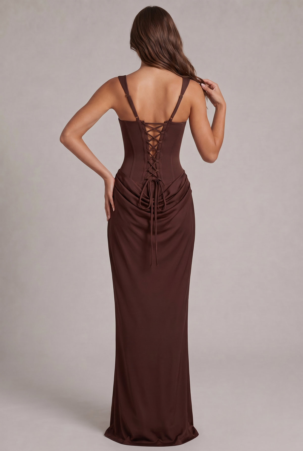 Back view of the chocolate brown dress, showing the corset lace-up back, adjustable straps and the long ties over the draped skirt. 4