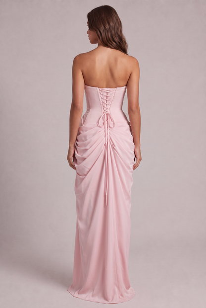 Back view of the pink gown with corset lacing and gathered drape falling to the hem 8