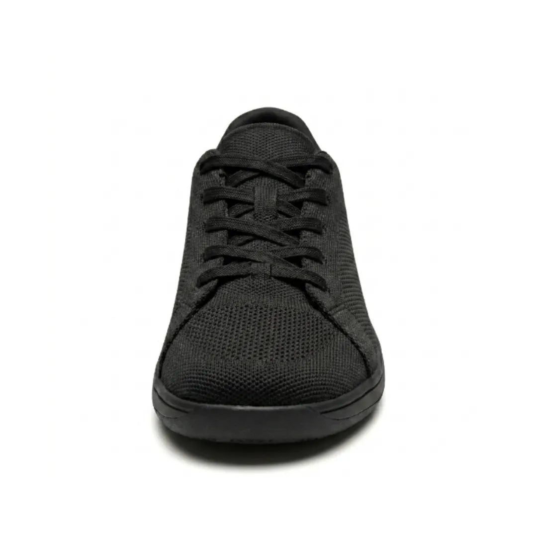 Front view of a black knit trainer showing the laces, rounded wide toe box and flat black sole. 17