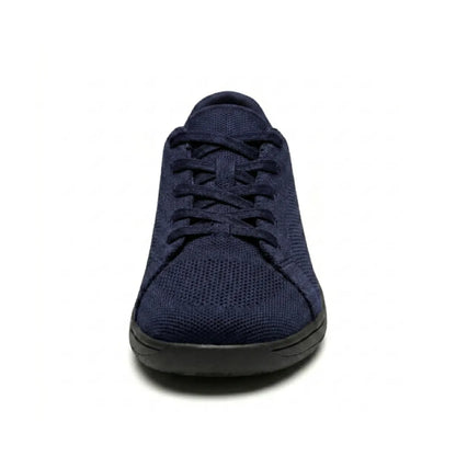 Navy knit trainer seen from the front, showing criss-cross laces, rounded toe cap and flat black sole. 26