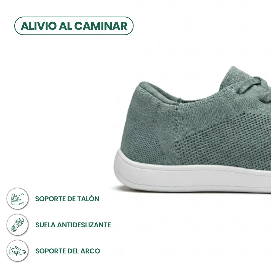 Close-up of the heel and side of a sage green knit trainer with white sole, with small feature icons beneath. 31