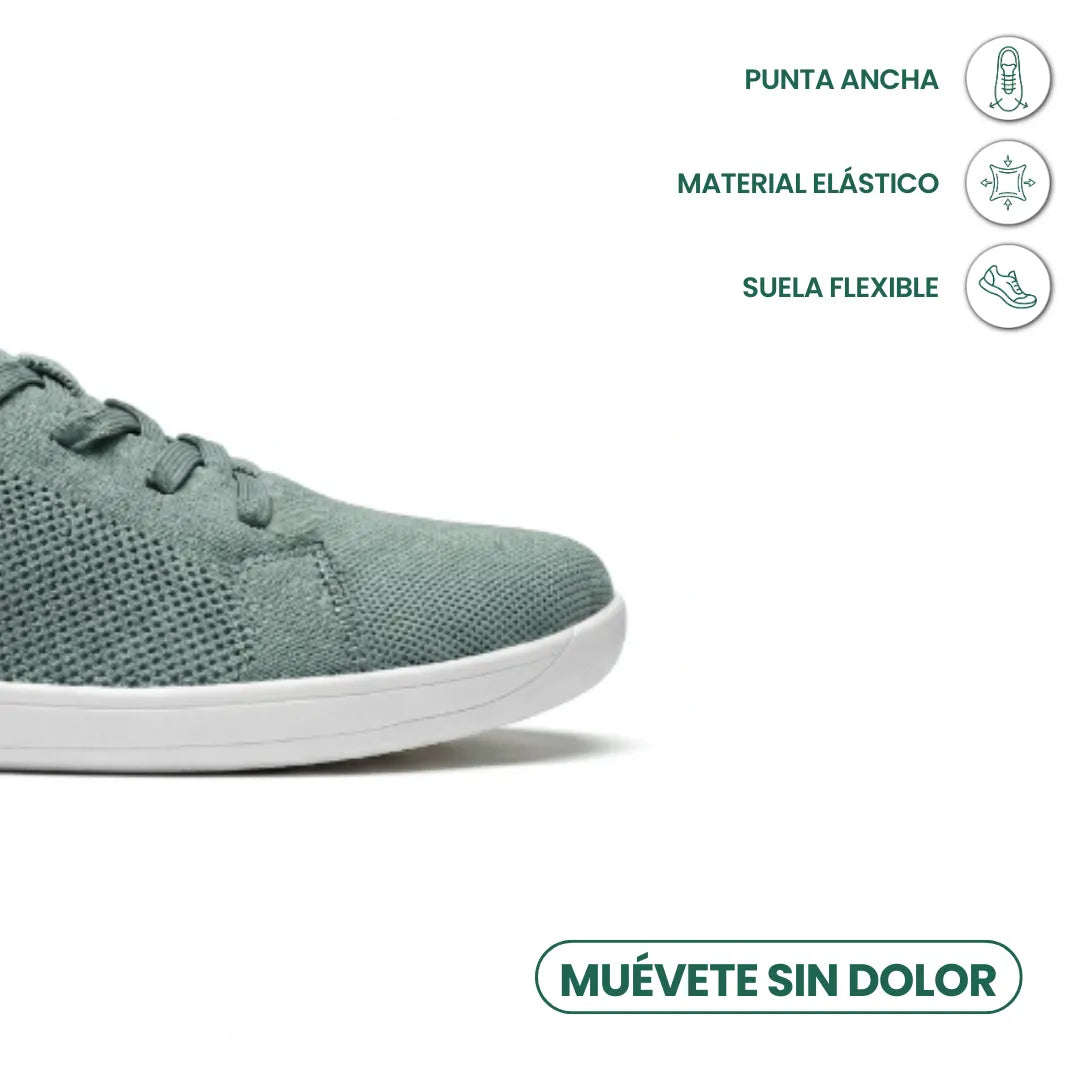 Close-up of the rounded toe of a sage green knit trainer with white sole, with feature icons above. 32