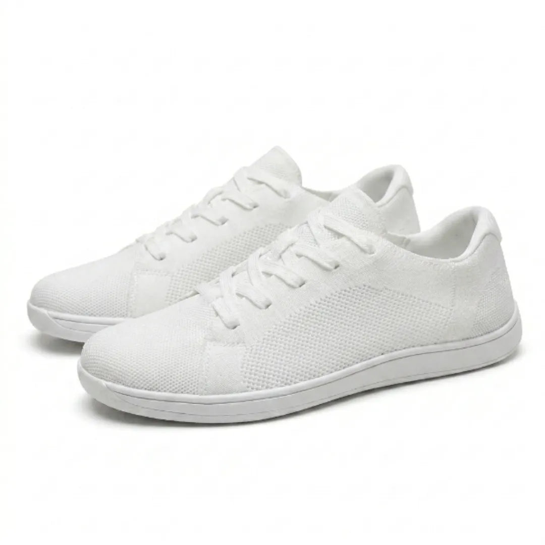 Pair of white knitted mesh lace-up trainers with thin white soles, shown at a three-quarter angle on a plain background. 43