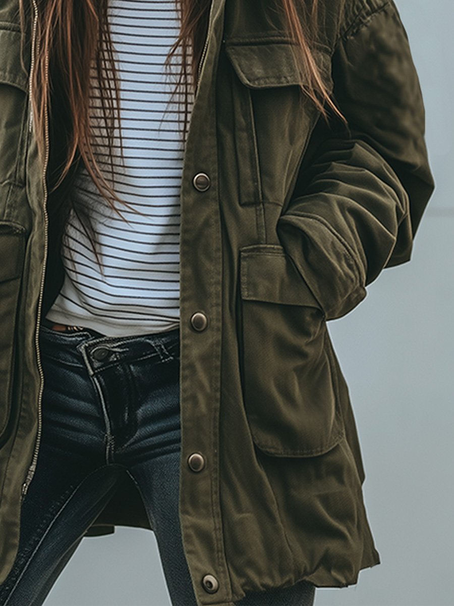 Close-up of the snap-button front placket and large flap pockets, worn open over a striped top and dark jeans. 3