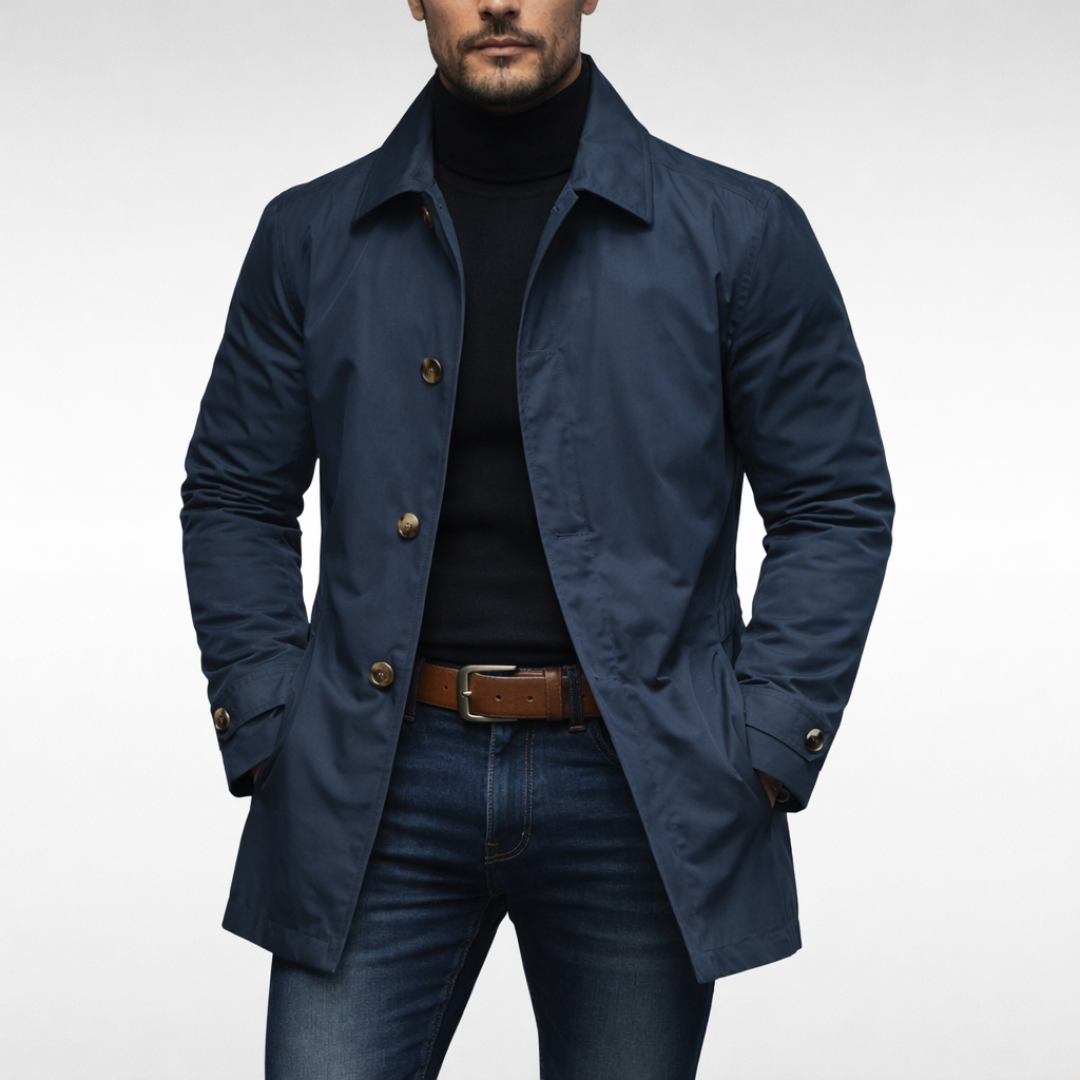 Front view of the same jacket in navy with light brown buttons, worn open over a black roll-neck and jeans. 2