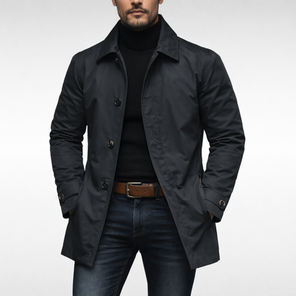 Front view of the jacket in black with dark buttons, worn open over a black roll-neck, jeans and tan belt. 3