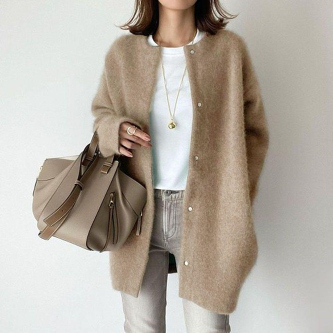 Model wears the fluffy snap-button cardigan in camel with a white tee, grey jeans and a taupe handbag 1